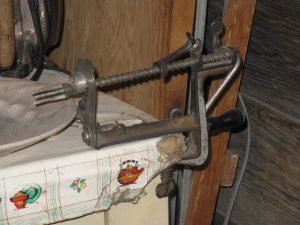 Antique apple corer and peeler is shown in the photo. The corer clamps to the table corner and turns by a handle 