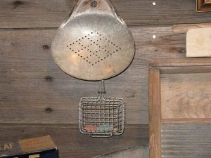 A metal basket is used to pick up chips of soap to re-use. 