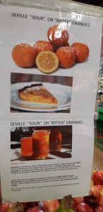 Italian Centre poster above bin of Seville oranges